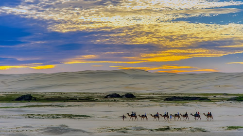 Climbing a desert dune in Egypt