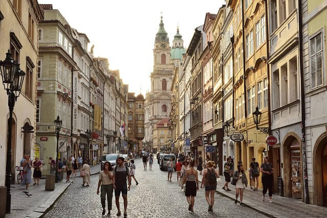 People walking busy street in the old town of Prague.